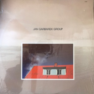 Jan Garbarek Group - Photo With Blue Sky, White Cloud, Wires, Windows And A Red Roof